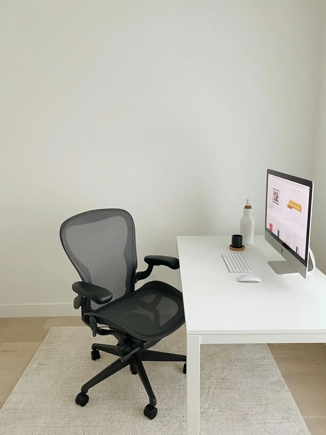 A cozy office setup featuring Christmas decor, a mug, and a laptop screen displaying a website.